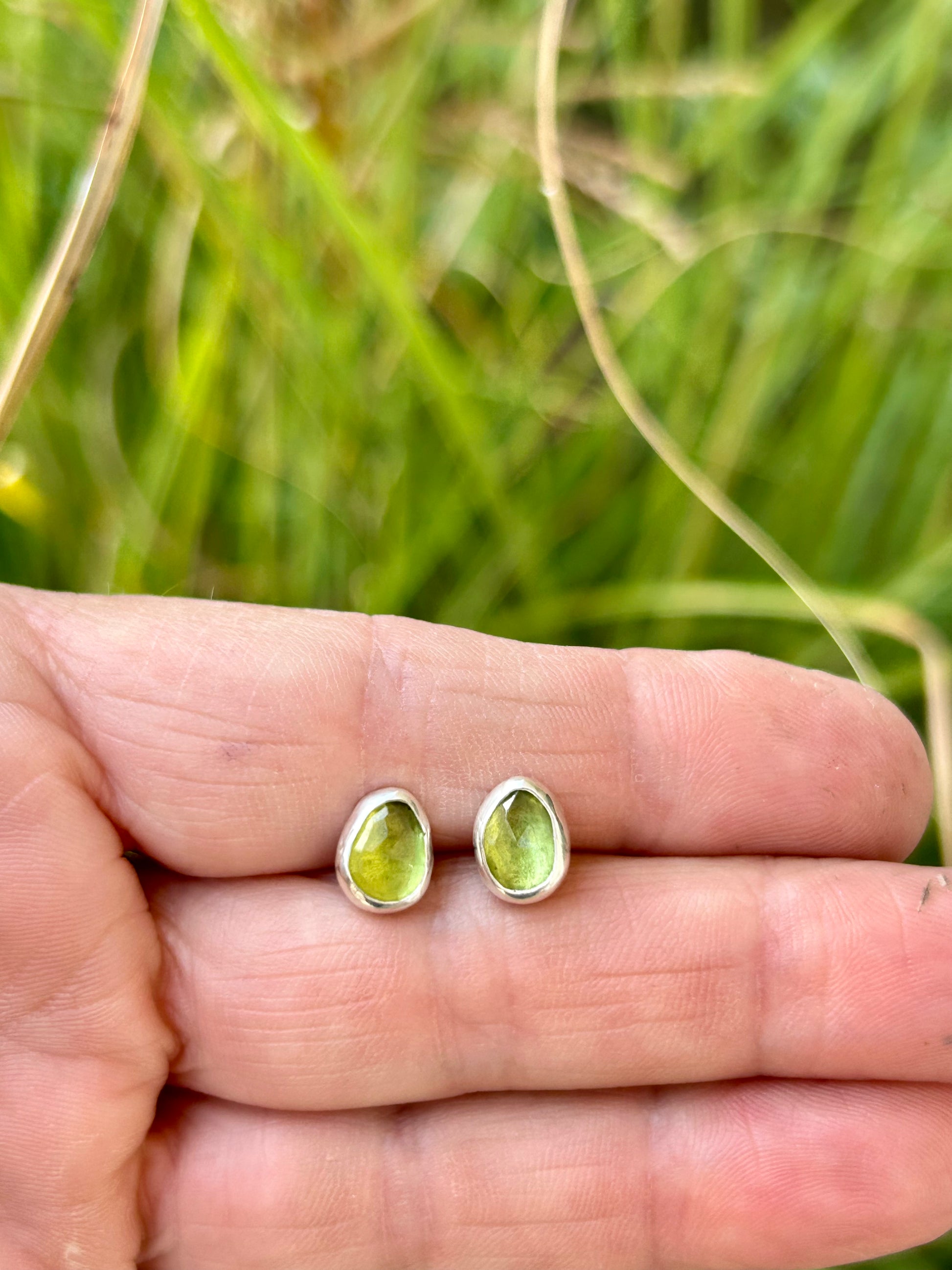 Green peridot gemstones set in sterling silver with silver posts and ear backs.