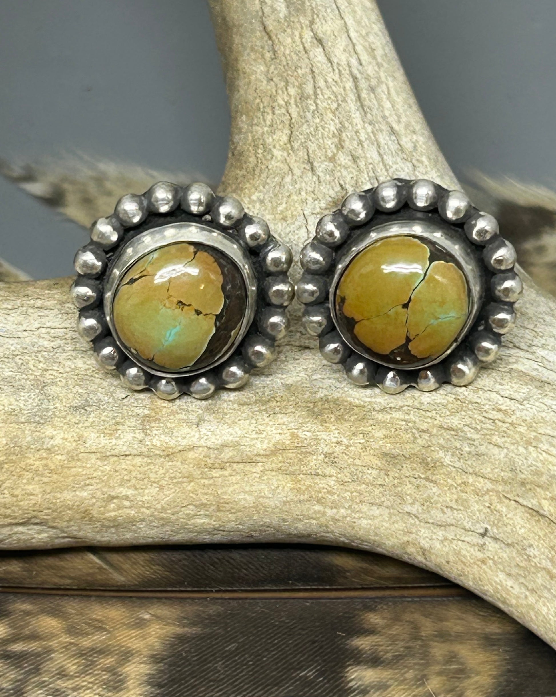 Round polychrome turquoise cabochons set in sterling silver accented with silver bead wire and a soft patina.