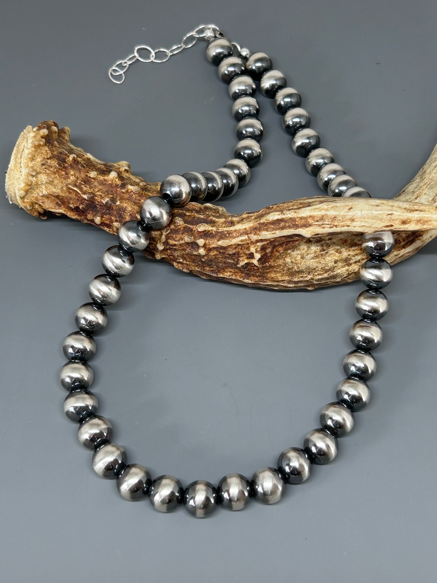 10 mm sterling silver beads hand strung, 18 inches long with a two inch extension.