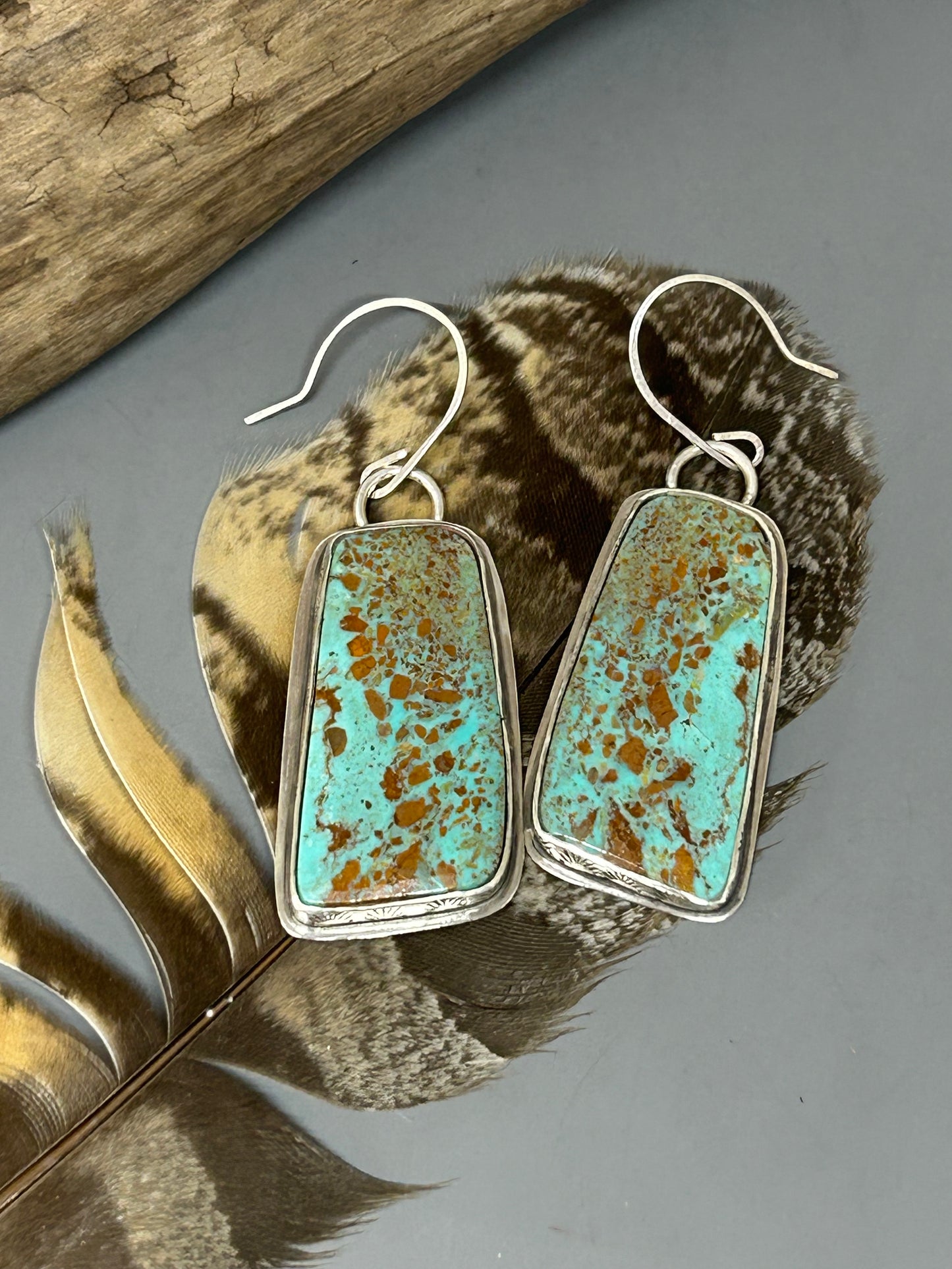 Large Alacron turquoise cabochons set in a sterling silver hand stamped bezel with sterling back plates and ear wires.