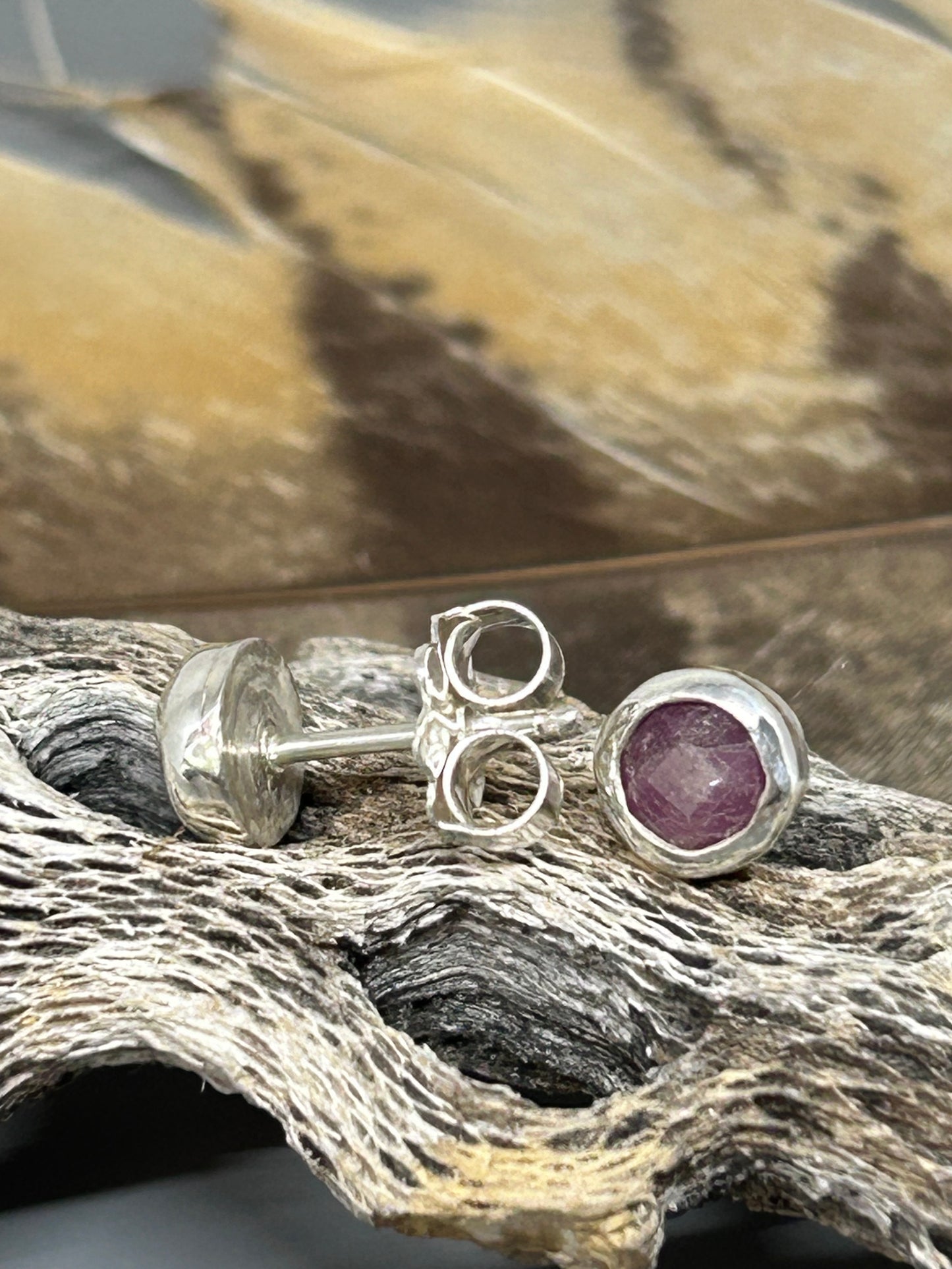 Round fose cut rubies set in sterling silver with silver posts and backs.  These stud earrings are 1/4 of an inch in diameter.