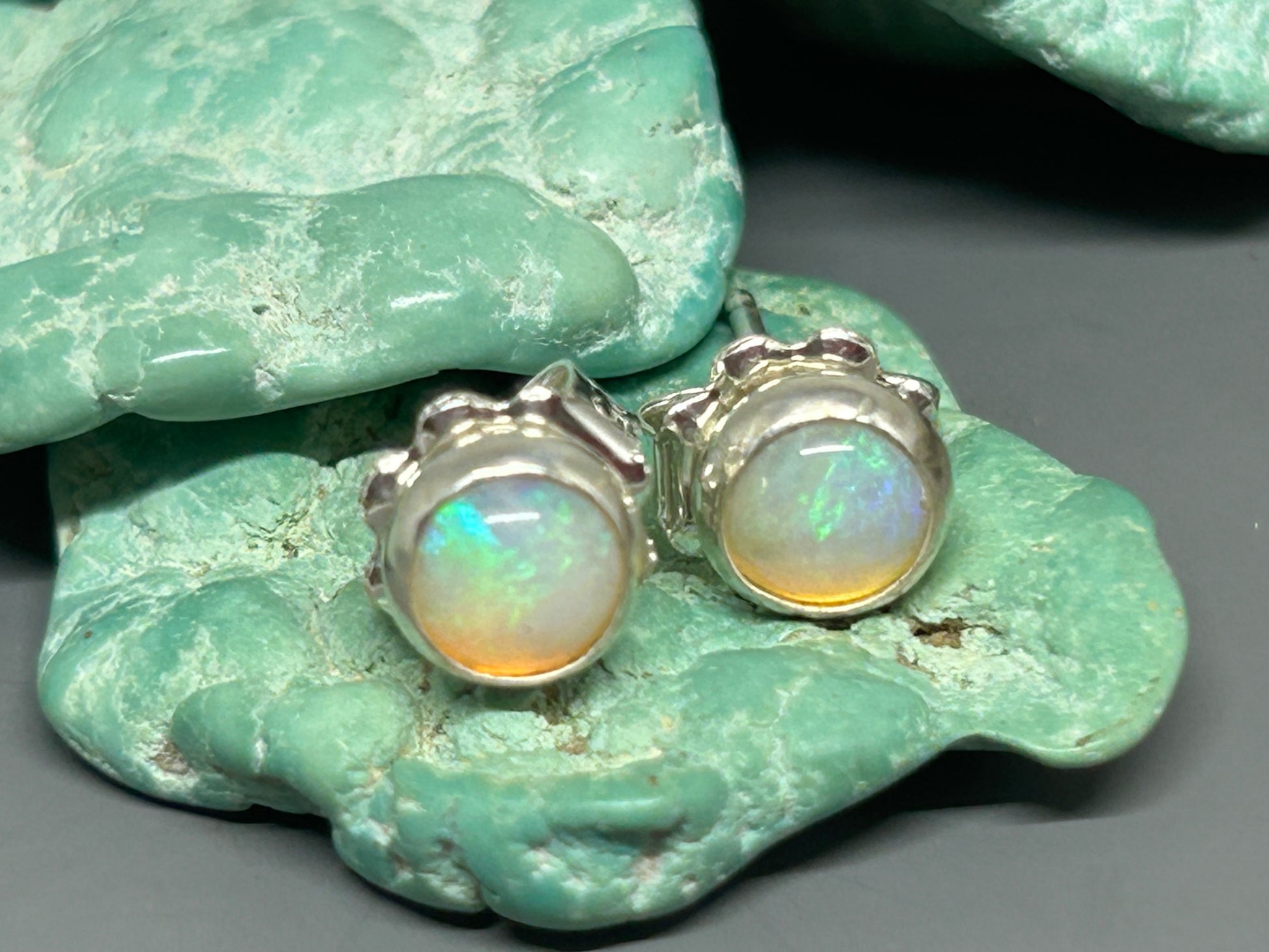 Round opals set in sterling silver with silver posts and ear nuts.
