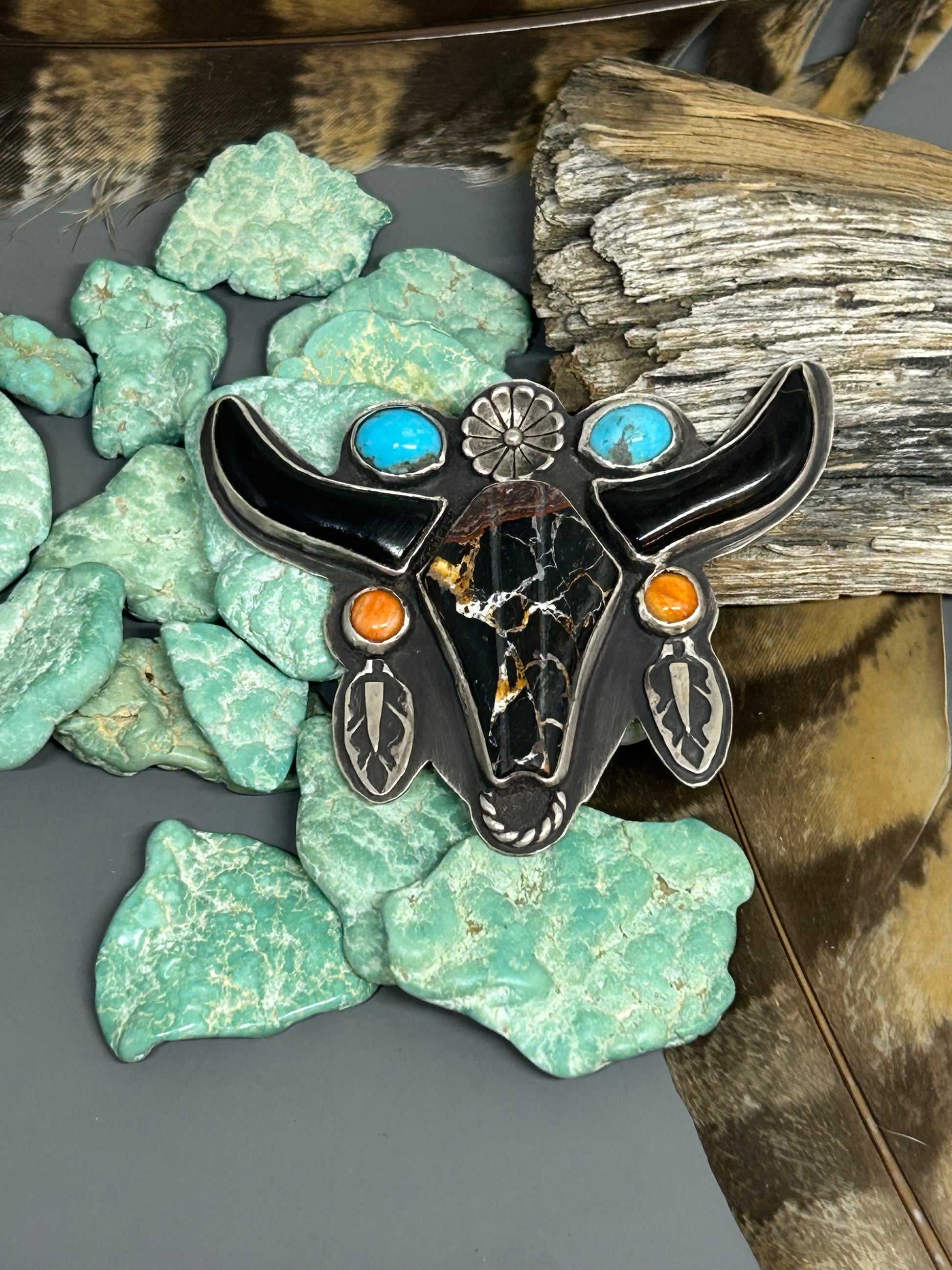 Iron buffalo and ox bone spiny oyster and turquoise set in sterling silver with hand stamped accents and a sterling silver flower in the design of a longhorn.