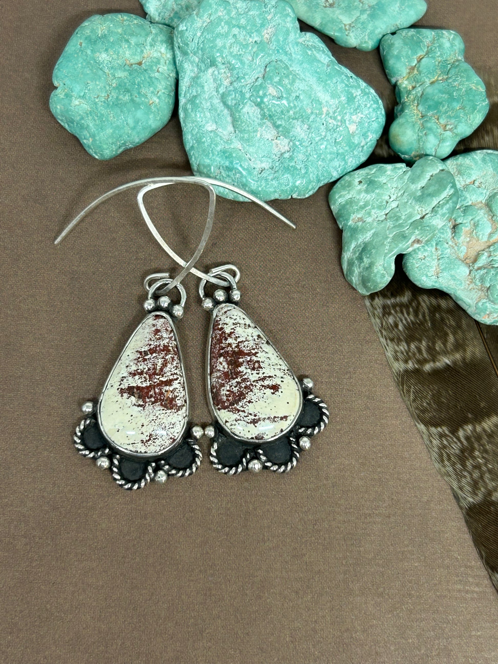 Red Buffalo cabochons set in sterling silver, 2 inches long.