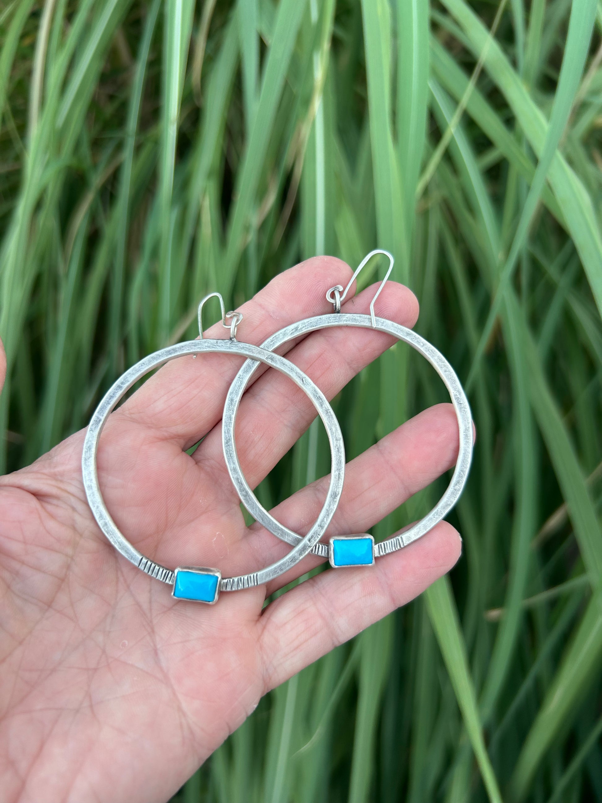 Hammered sterling silver hoops accented with hand stamping, Campitos turquoise and a soft patina. Hoops are 2 inches in diameter and hang three inches from the middle of the sterling silver ear wire.