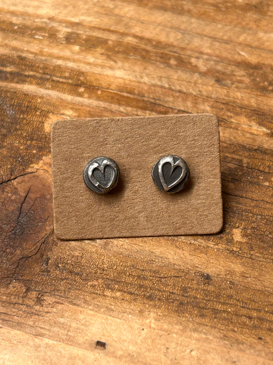 Sterling silver heart shaped stud earrings with sterling posts and ear backs.