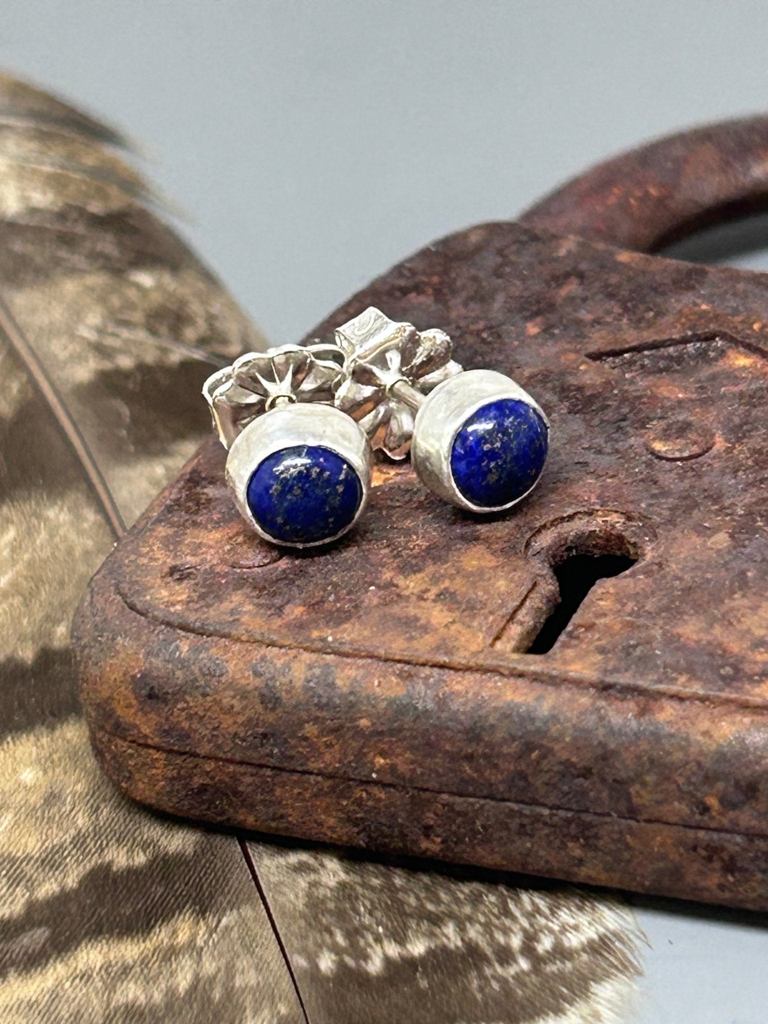 Round lapis with pyrire set in sterling silver with sterling silver ear posts and nuts. These stud earrings are 1/4 of an inch in diameter.