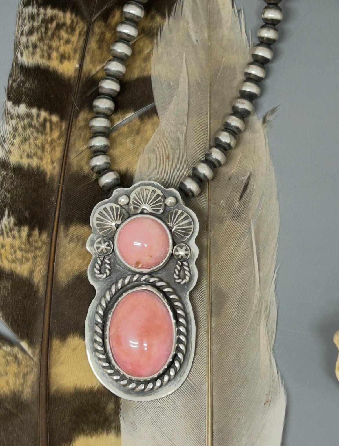 Natural pink opal set in a sterling silver desert maiden design.