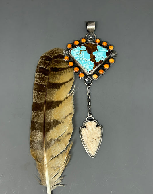 Mine number 8 turquoise surrounded by Spiny Oyster and Sterling silver accents and an arrowhead set in sterling silver.