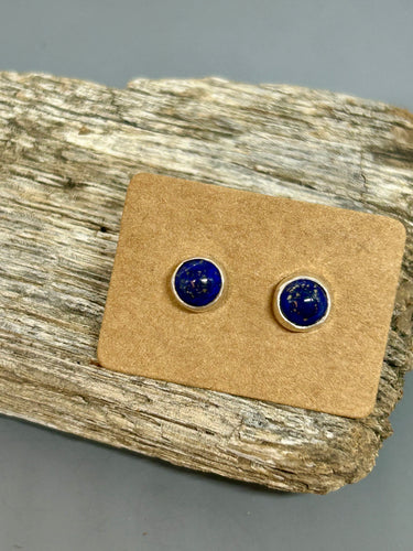 Small round Lapis cabochons set in sterling silver with sterling ear posts and backs, 1/4 of an inch in diameter.