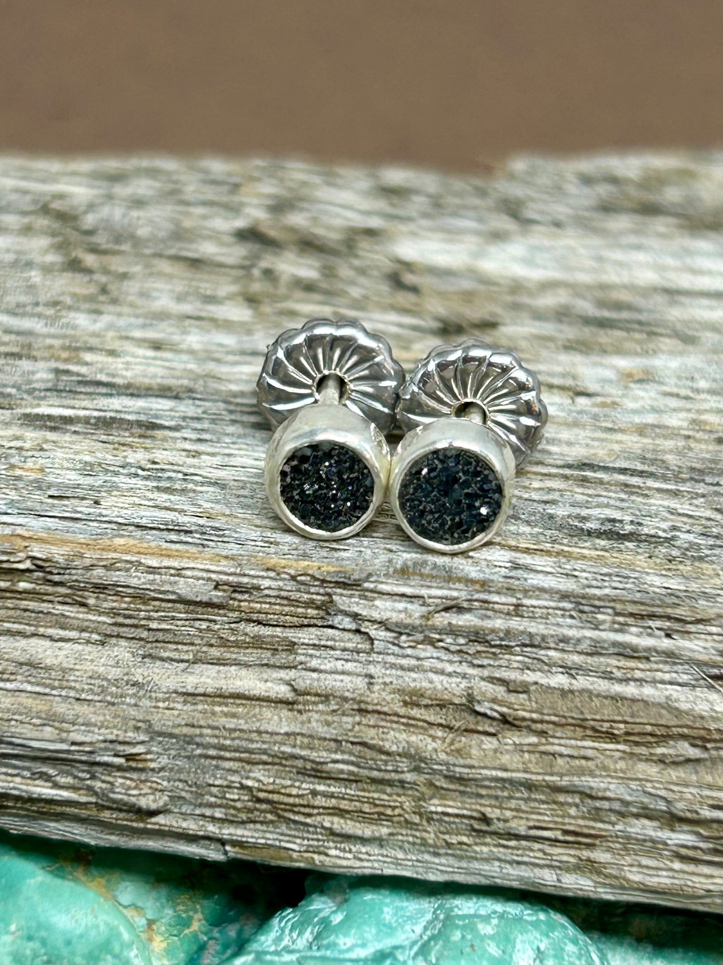 Small black druzy cabochons set in sterling silver with silver ear wires and posts.