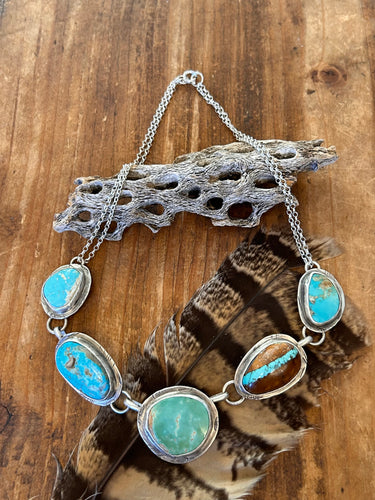 Five pieces of natural Royston turquoise from Nevada set in rustic sterling silver settings.  This necklace is 18 inches long.