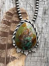 Load image into Gallery viewer, Southwestern Pendant. Green Patagonia Turquoise cabochon set in sterling silver accented with hand twisted silver wire and silver castings and balls.

