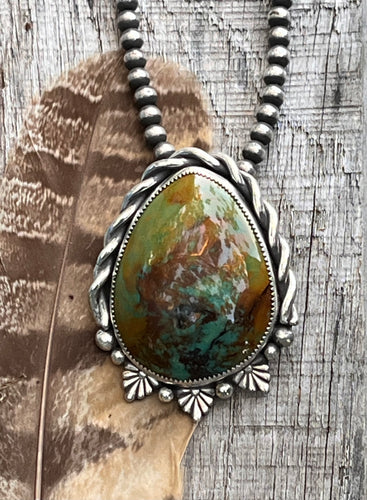 Southwestern Pendant. Green Patagonia Turquoise cabochon set in sterling silver accented with hand twisted silver wire and silver castings and balls.