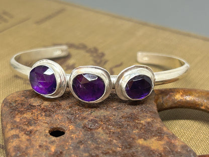 Three rose cut amethyst stones set in sterling silver on a 6 gauge 6 inch sterling silver cuff, adjustable.