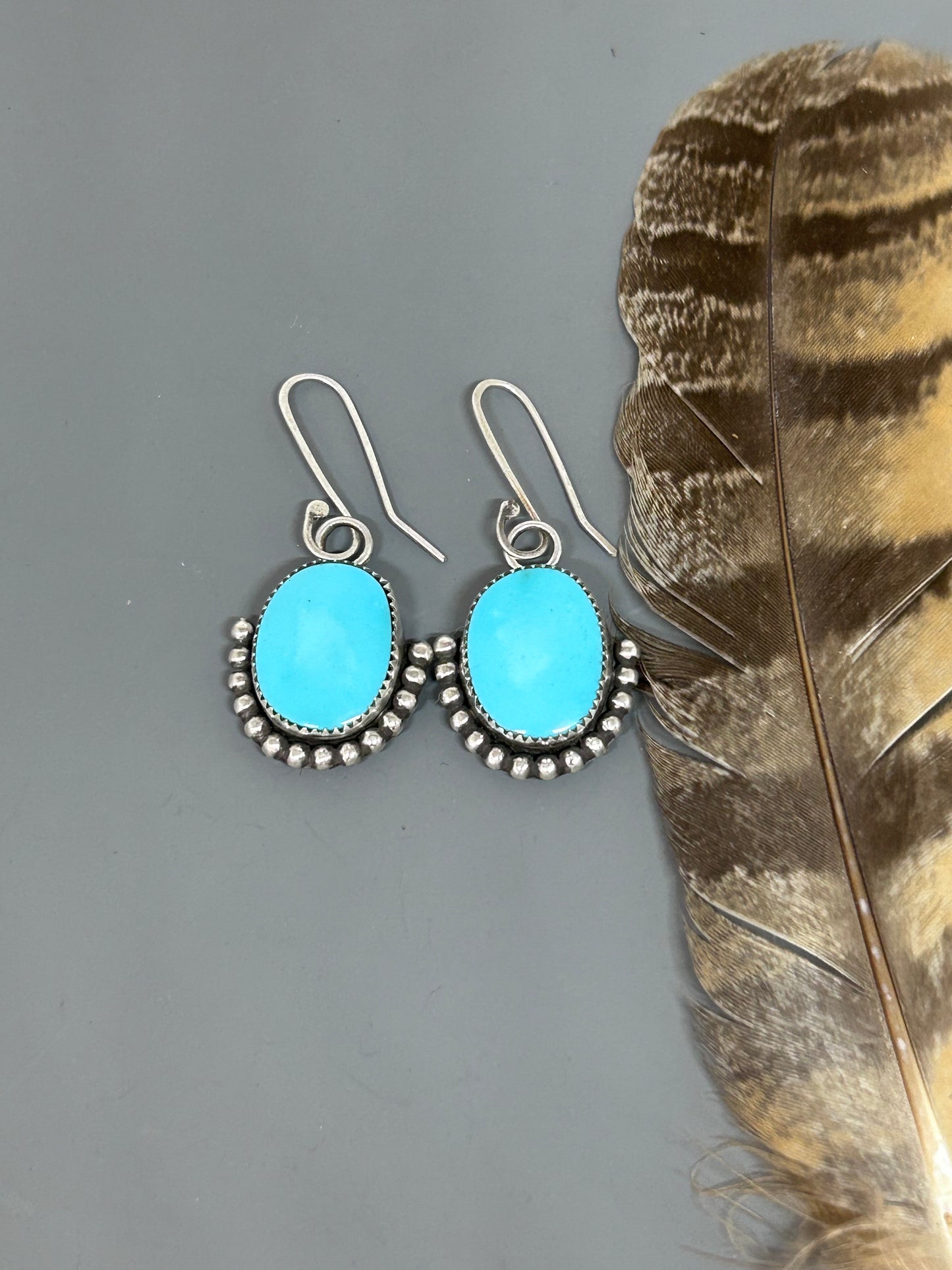 Blue Kingman Turquoise set in sterling silver accented with bead wire and sterling silver ear wires.