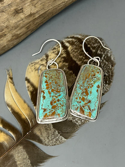 Large Alacron turquoise cabochons set in a sterling silver hand stamped bezel with sterling back plates and ear wires.