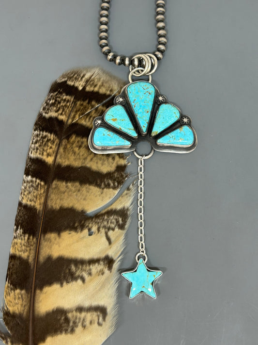 Sonoran Blue Turquoise set in sterling silver accented with silver concho stars, 5 1/2 inches long.