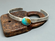 Load image into Gallery viewer, Natural Royston turquoise set in sterling silver. The band is sterling silver. Adjustable with Tuff Gurlz and a distressed markings hand stamped into it.
