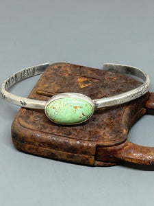 Oval natural Royston turquoise set in sterling silver. The cuff is sterling silver, six inches long and adjustable.