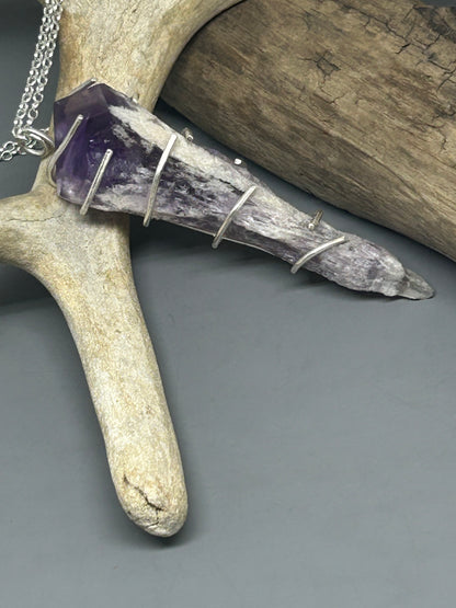 Amethyst crystal in sterling silver prong setting in sterling silver on an 18 inch sterling silver chain.