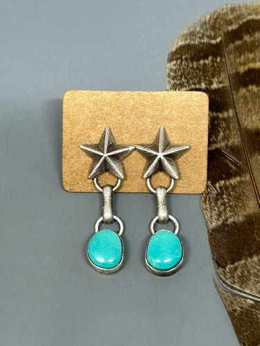 Kingman turquoise set in sterling silver hang below sterling silver southwestern stars. The ear post snd nut are sterling silver.