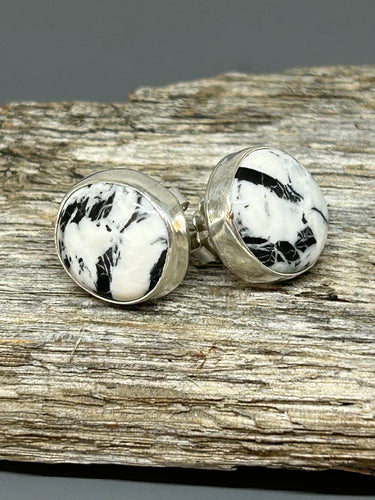 Round White Buffalo cabochons set in sterling silver with silver ear posts and backs. These southwestern earrings are 1/4 of an inch in diameter.