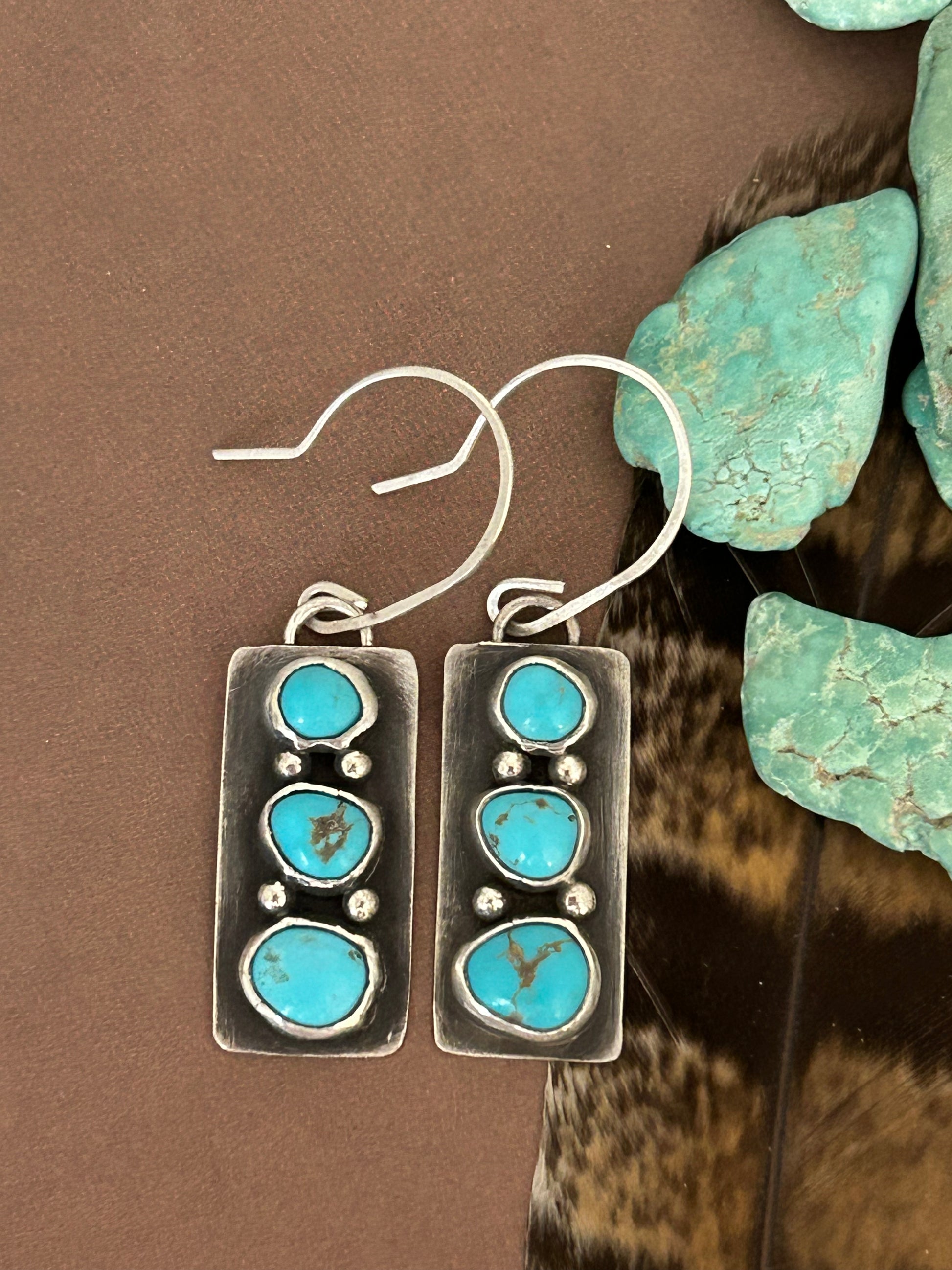 Blue Evans turquoise set in lightweight sterling silver with a soft patina. Dangle earrings 1.75 inches long.