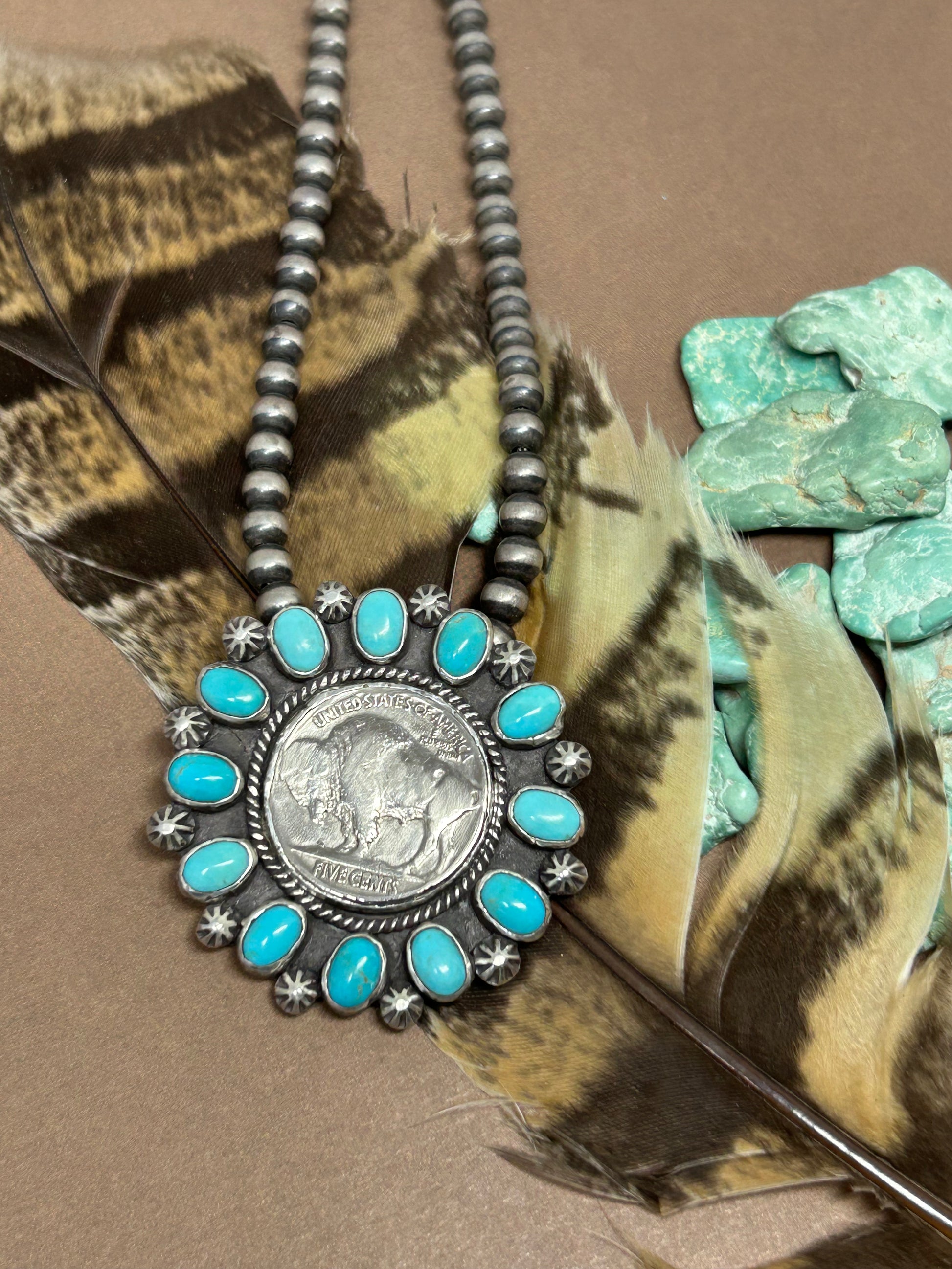 Antique buffalo head nickel set in sterlin gsilver accented with genuine rare sleeping beauty turquoise and sterling silver.