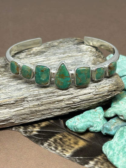 Rare Ajax turquoise set in ssterling silver on a solid thick sterling silver adjustable band.
