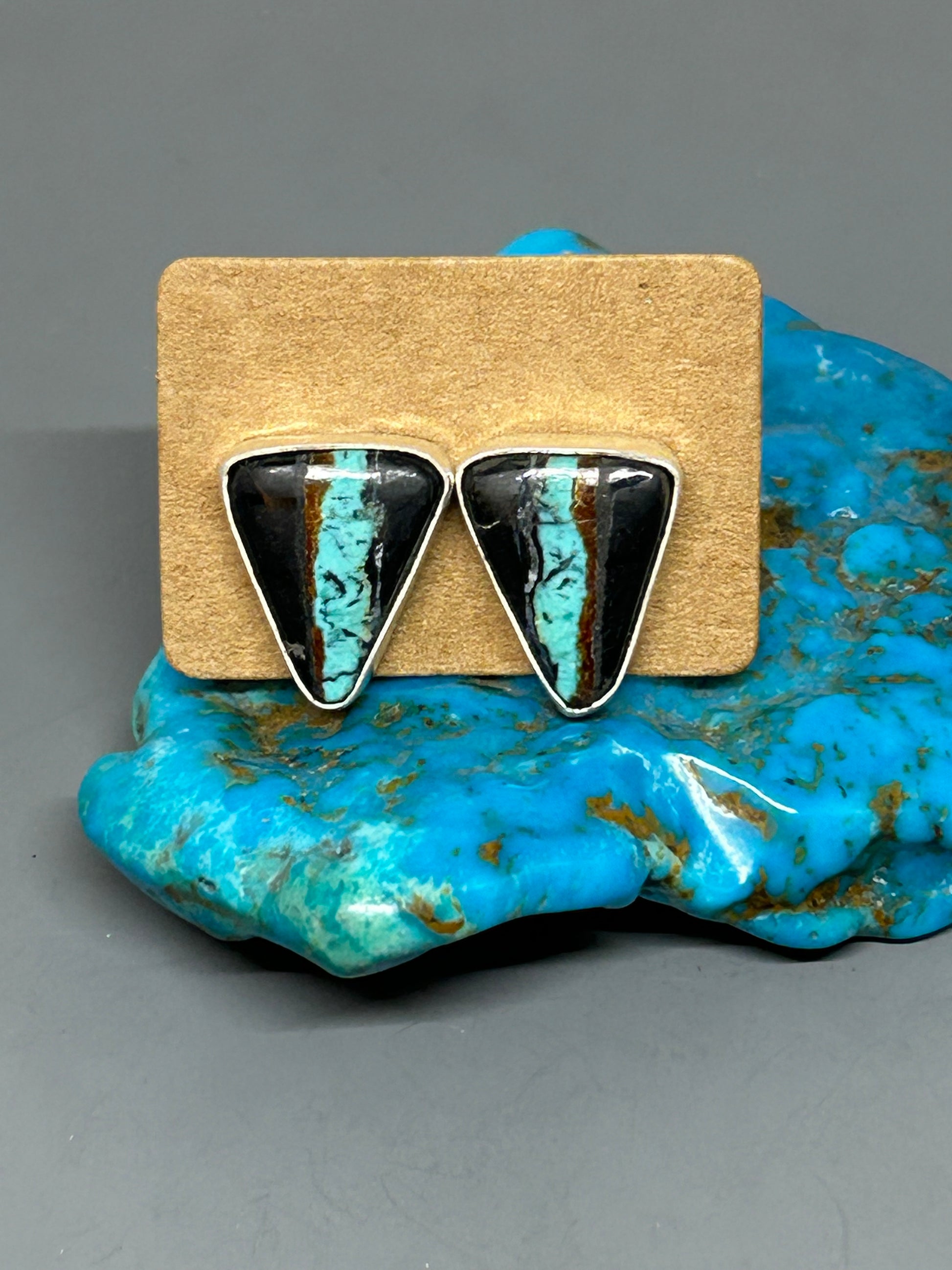 Triangle shaped blackjack turquoise set in sterling silver with silver posts and ear backs.