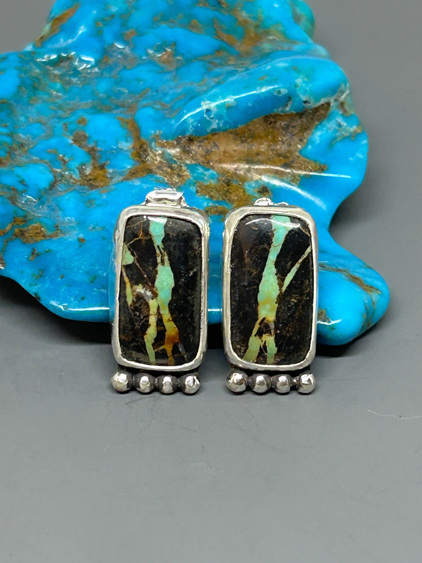 Blackjack turquoise set in sterling silver. sterling silver posts and ear backs.