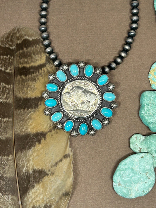 Buffalo head nickel surrounded with rare sleeping beauty turquoise set in solid sterling silver accented with sterling silver accents.