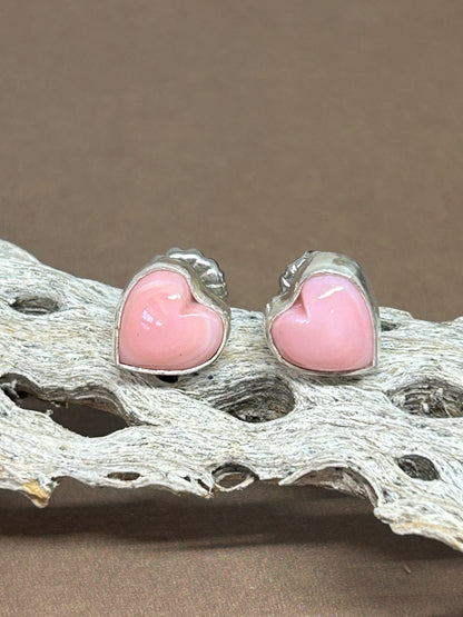 These pink conch shell earrings were made with sterling silver and natural pink conch shell. a perfect simple pop of color and light weight for everyday!