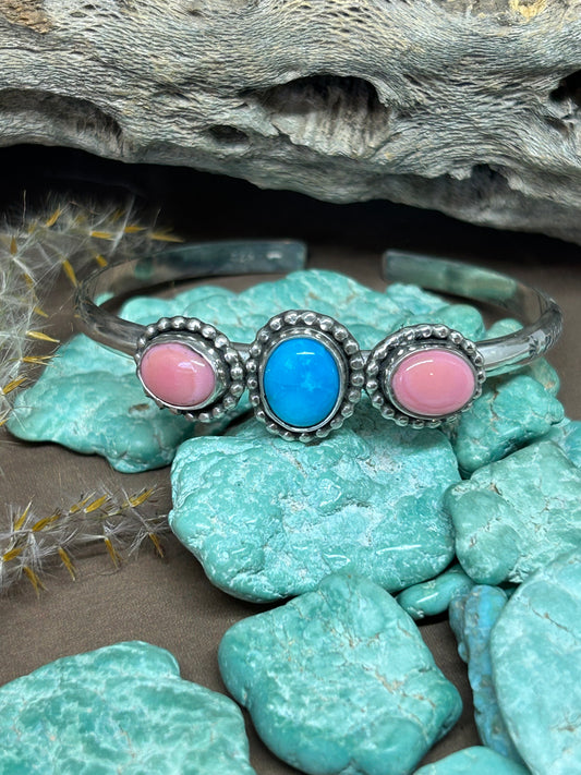 This sterling silver Kingman turquoise and pink conch shell bracelet is a reminder to stay grounded during transformation. 6 inches long with a one inch gap.