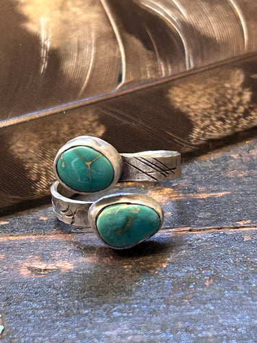 Two pieces of Royston turquoise in a sterling silver distressed setting on an adjustable sterling silver band.