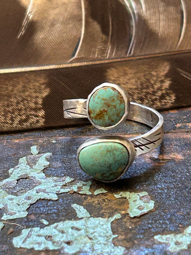 Two pieces of natural Royston turquoise set in rustic sterling silver settings on an adjustable band.