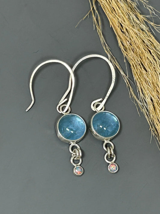 Round aquamarine stones set in sterling silver accented with 4mm opals.