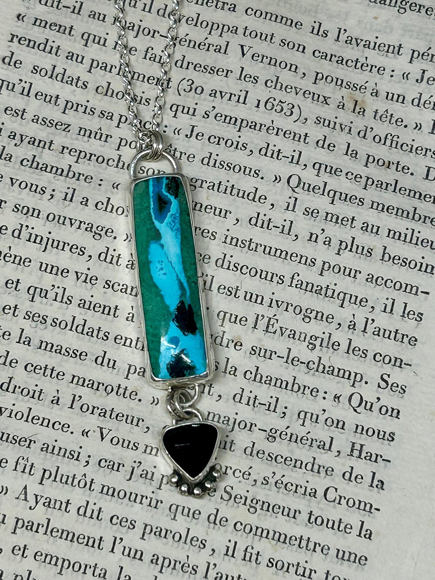 This Chrysocolla Malachite Tenorite And Black Onyx necklace is a heirloom piece and all stones are set in sterling silver and hang on an 18 inch sterling silver chain,