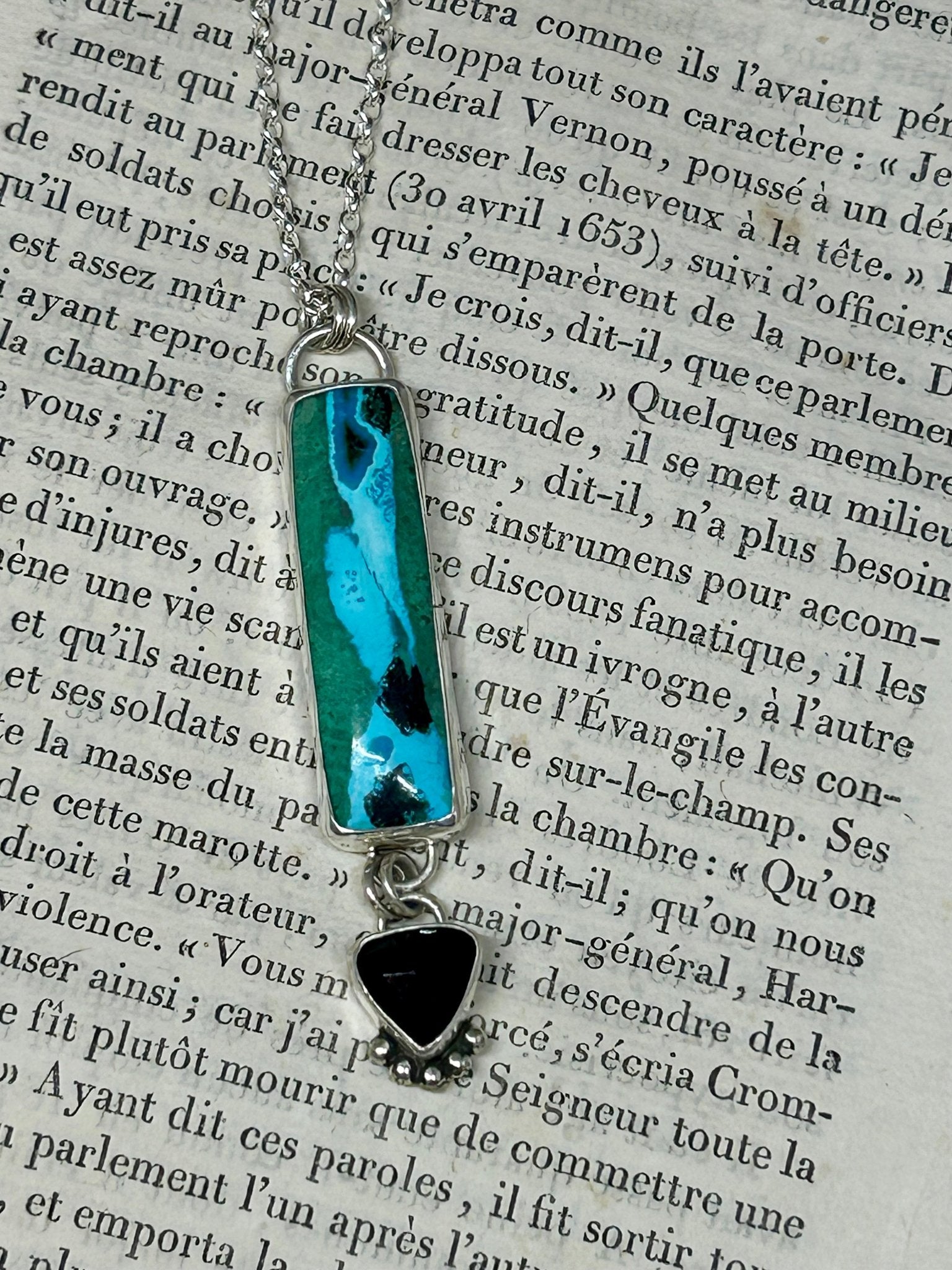 This Chrysocolla Malachite Tenorite And Black Onyx necklace is a heirloom piece and all stones are set in sterling silver and hang on an 18 inch sterling silver chain,