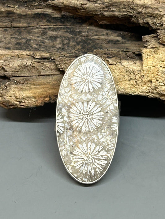 Fossilized coral set in sterling silver with a shiny finish size 7 sterling silver half round band.