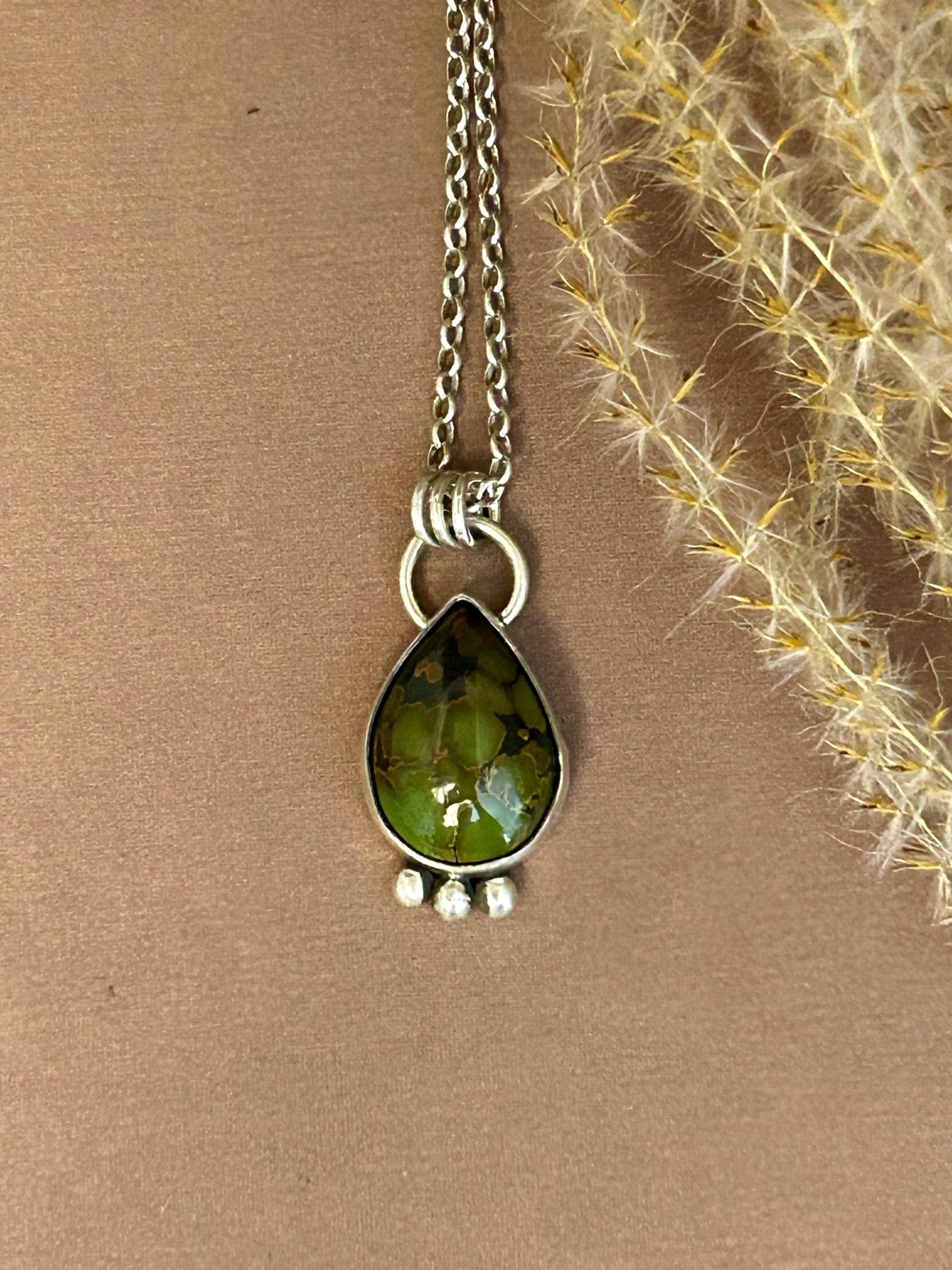 This Hubei turquoise cabochon is set in sterling silver accented with three silver balls, it hangs on an 18 inch sterling silver chain.