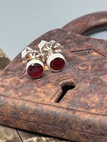 Round garnet rose cut gemstones 5 mm in diameter set in sterling silver with silver posts and ear nuts.