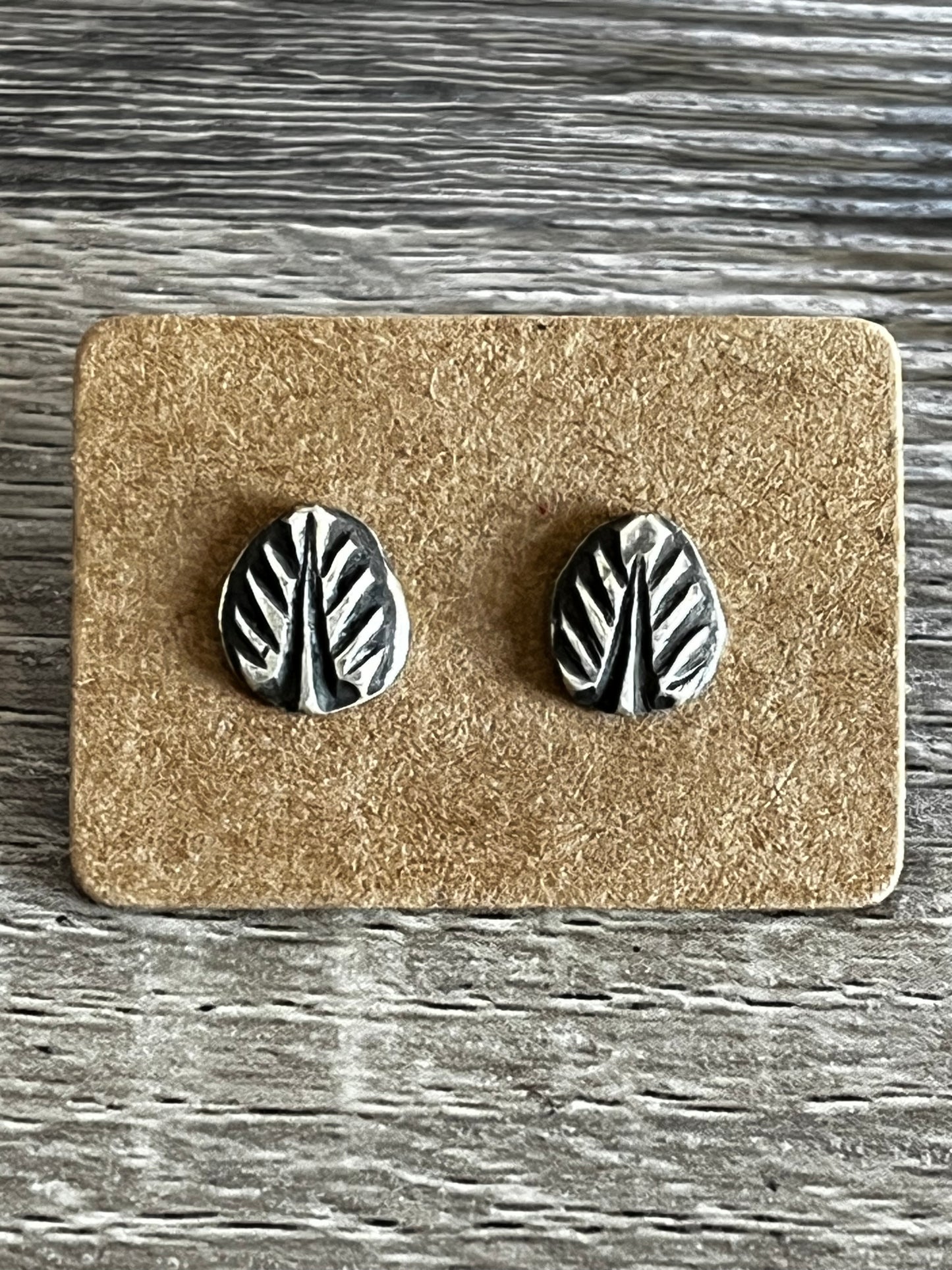 Sterling silver leaf earrings with a soft patina, silver ear posts and backs.