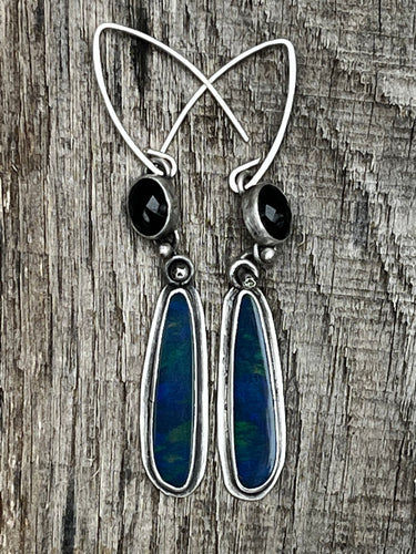 Black Onyx and Opal doublet sones set in sterling silver. These earrings are 2 1/2 inches long from the middle of the sterling silver ear wire. Handmade by Taylor Made Silver.
