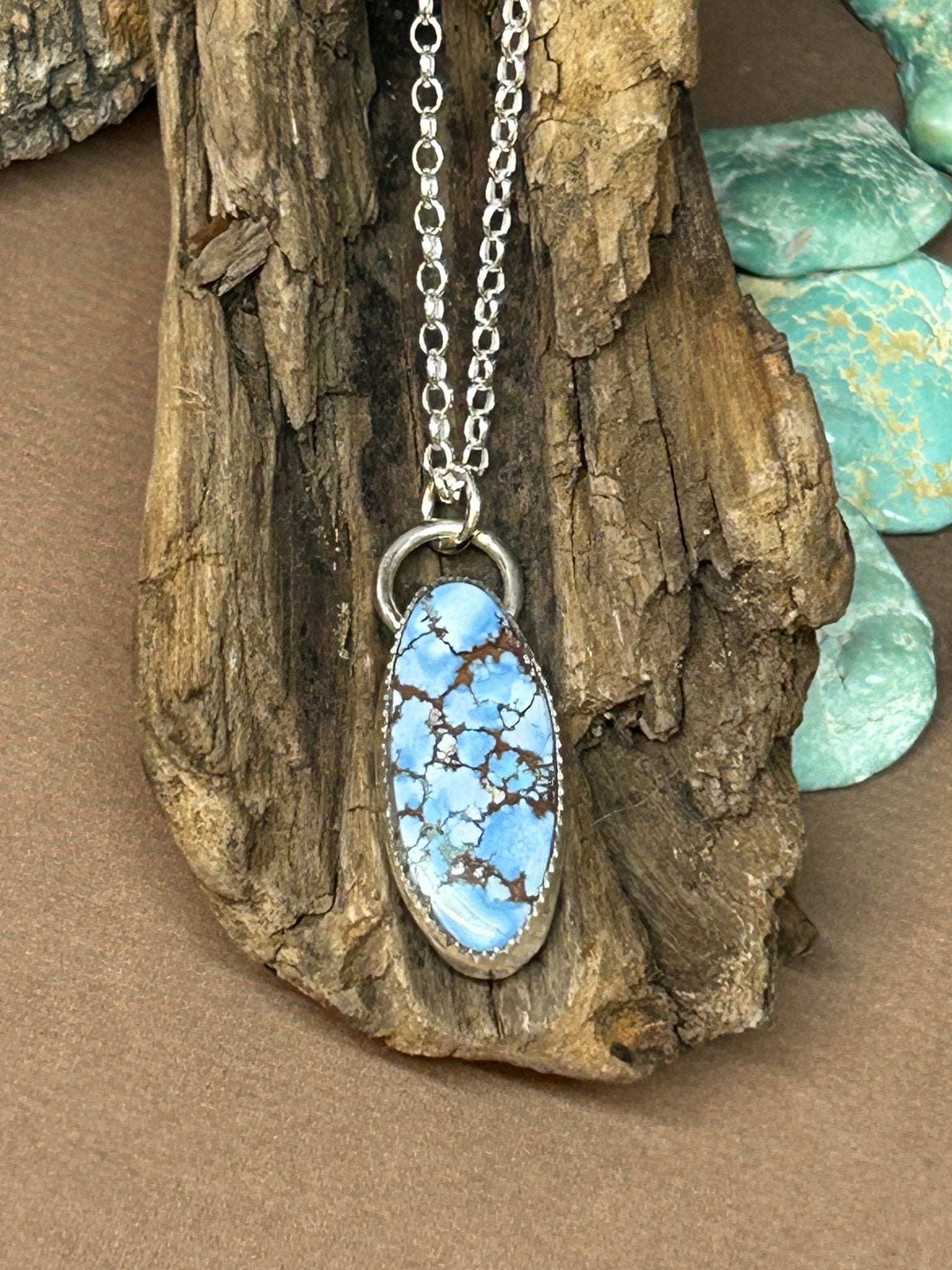 This lavender turquoise cabochon is set in a simple sterling silver setting on an 18 inch sterling silver chain. 
