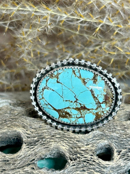This mine number 8 turwuoise cabochon is set in sterling silver with silver bead accents on a size 8.5 sterling band.
