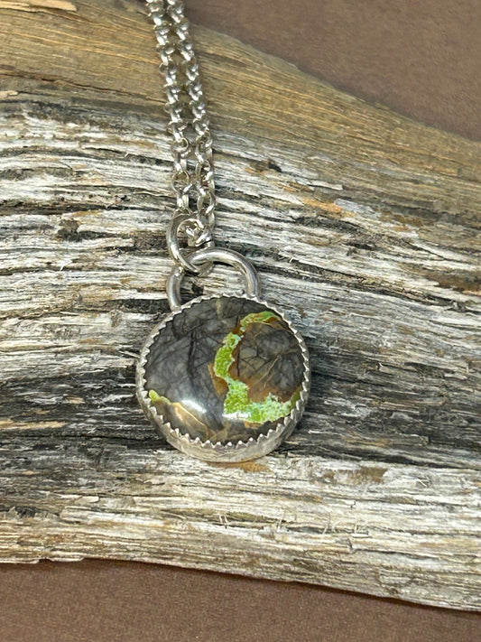 This Northern lights turquoise is set in a simple silver setting on an 18 inch  sterling silver chain.