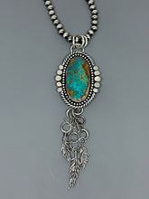 Load image into Gallery viewer, Southwestern pendant. High grade Royston Turquoise set in sterlin gsilver accented with silver bead wire, twist wire, hammered balls and three dangling sterling silver hand cast feathers.
