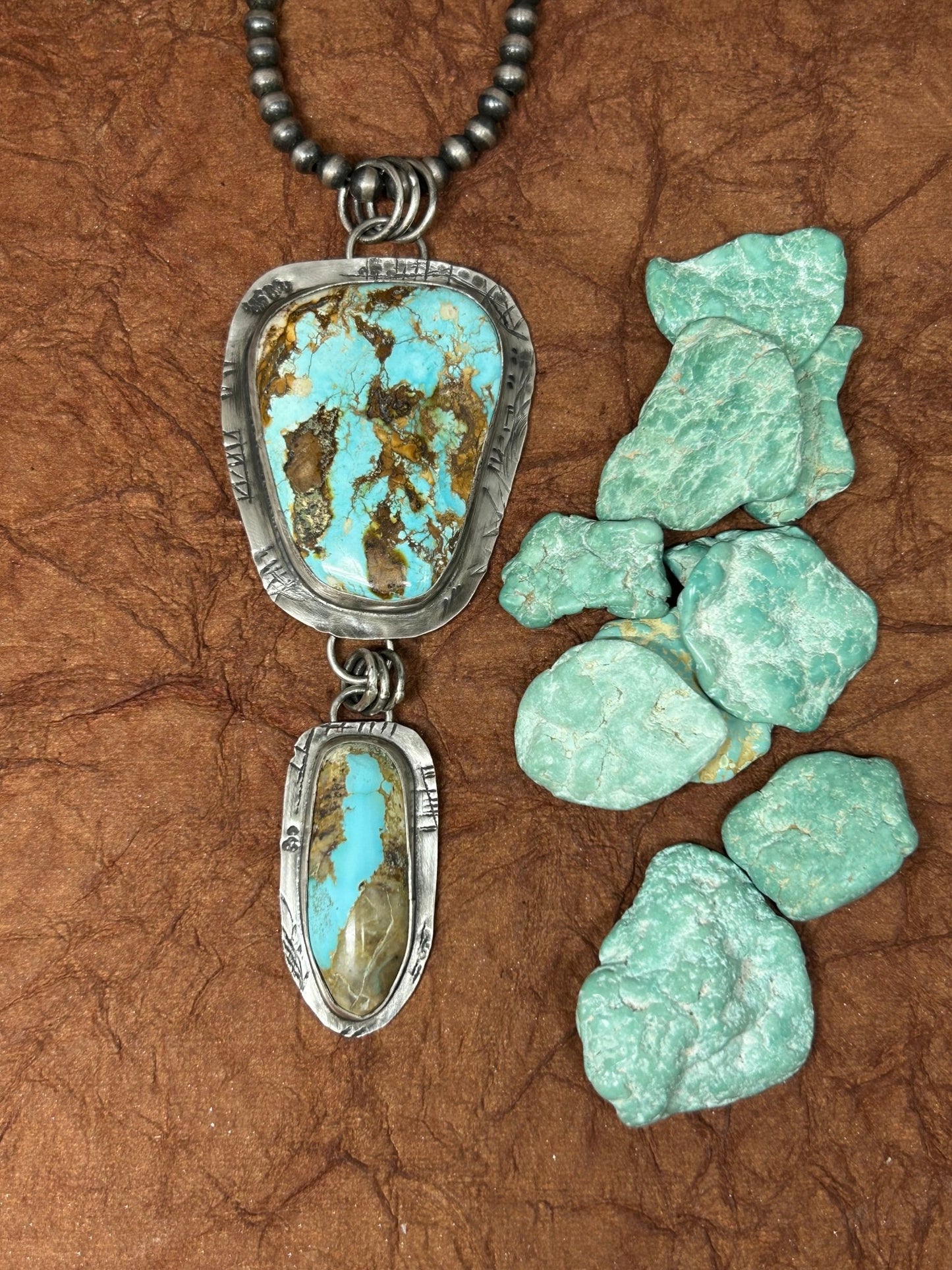 This royston tuff gurlz necklace was handcrafted with two royston turquoise stones set in sterling silver in a rustic setting.